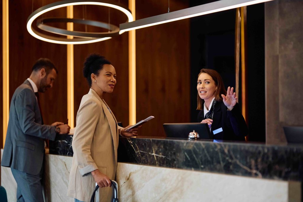 A guest checking in at a hotel reception desk
