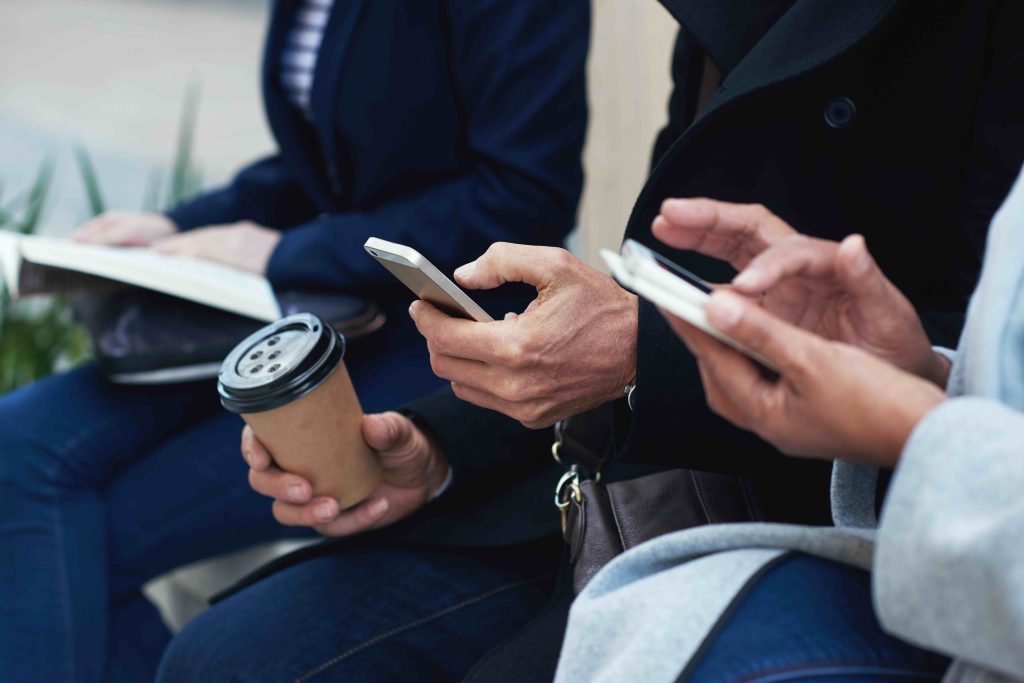 Former guests reading a follow-up message on their phones