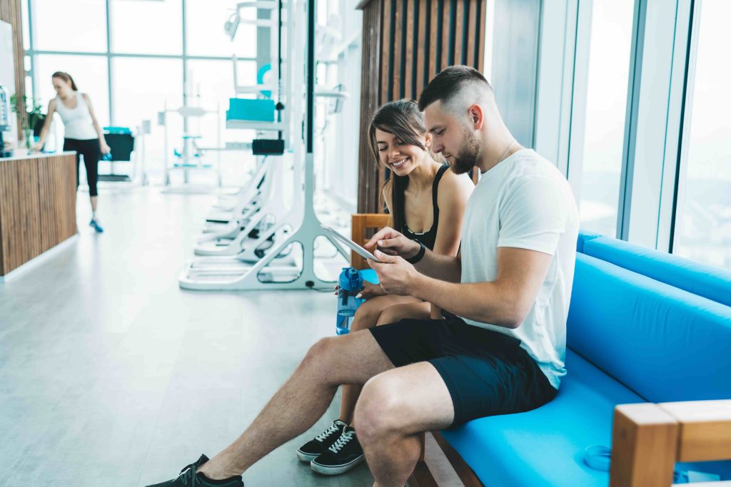 Two gym members looking at a membership option together