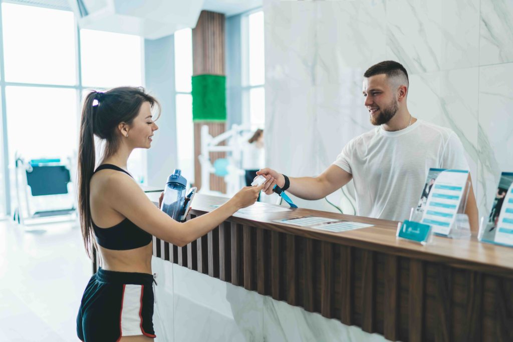 Reception team member helping a customer at a leisure club
